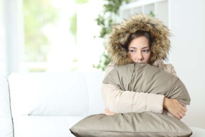garner-woman-warmly-clothed Garner Heating & Air Conditioning provides heat pump installation in Hays County Texas